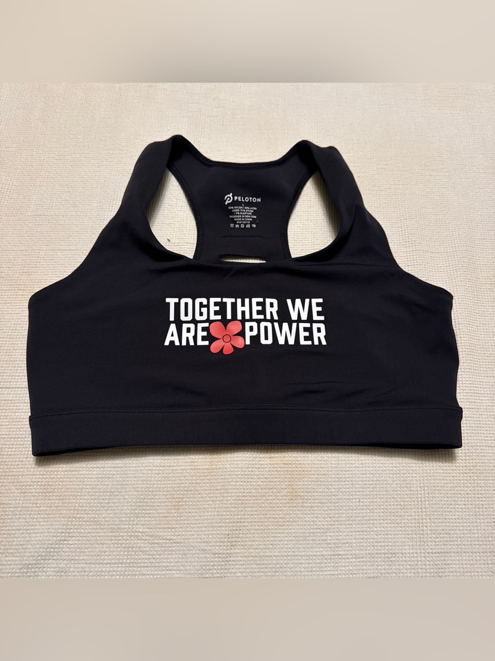 Peloton Black Sports Bra with White Slogan and Red Flower